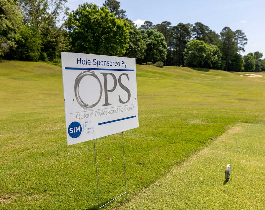 Optomi Charlotte Community Involvement SIM Golf Event Optomi Professional Services sign