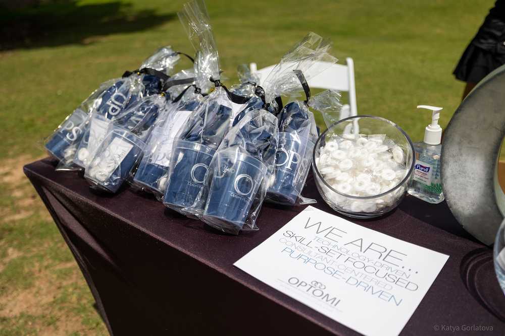 Optomi Charlotte Community Involvement SIM Golf Event table swag